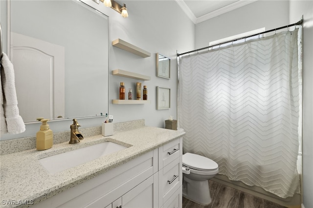 bathroom featuring vanity, toilet, wood finished floors, and ornamental molding