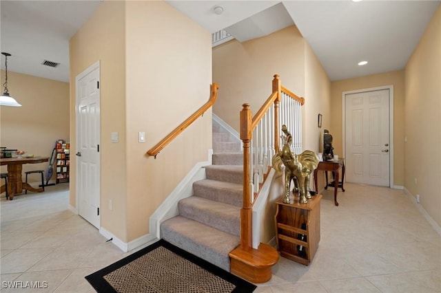 stairway featuring tile patterned flooring, recessed lighting, baseboards, and visible vents