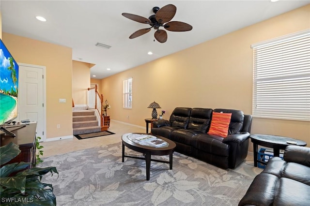 living room with visible vents, recessed lighting, ceiling fan, stairs, and carpet flooring