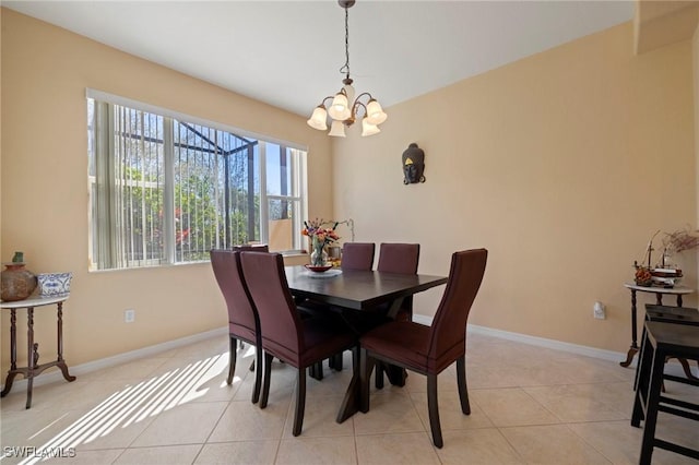 dining space featuring an inviting chandelier, light tile patterned floors, and baseboards