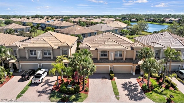 bird's eye view with a residential view and a water view