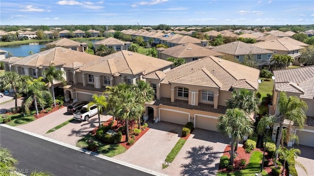 drone / aerial view featuring a residential view and a water view