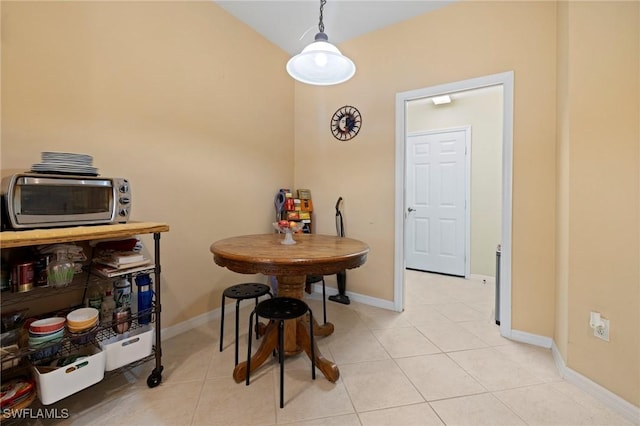 dining room with light tile patterned flooring and baseboards