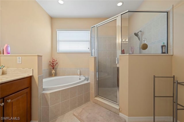 bathroom with vanity, recessed lighting, a shower stall, a garden tub, and tile patterned floors