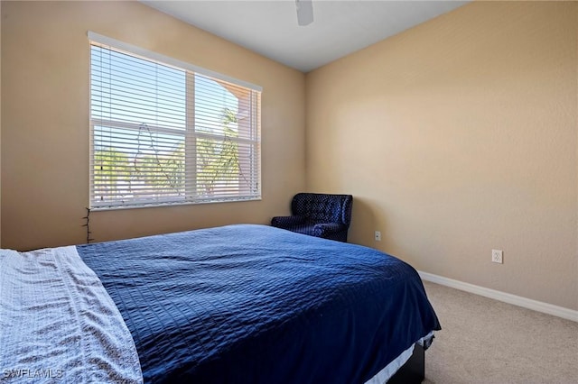 carpeted bedroom with baseboards and ceiling fan