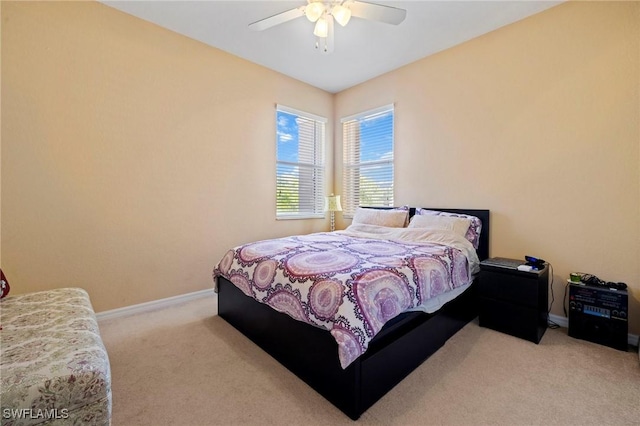 carpeted bedroom with baseboards and ceiling fan