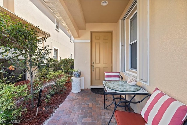 property entrance featuring stucco siding