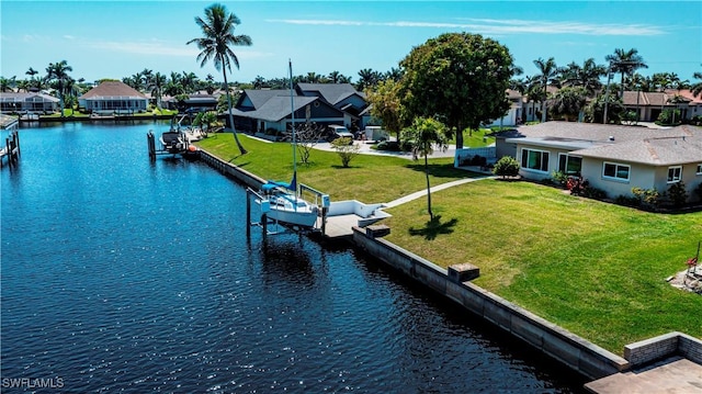 view of dock with a yard, a residential view, boat lift, and a water view