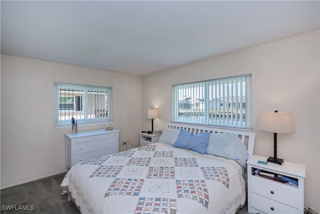 bedroom with dark colored carpet