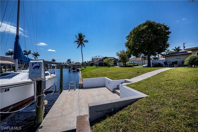 dock area with a yard and a water view