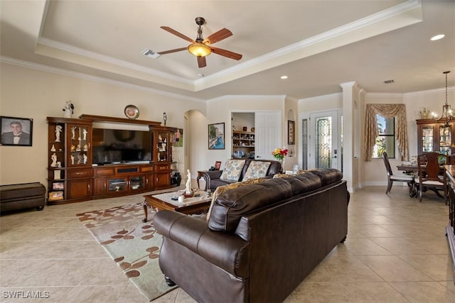 living area featuring visible vents, a ceiling fan, crown molding, light tile patterned floors, and a raised ceiling