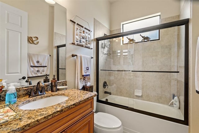 full bathroom featuring enclosed tub / shower combo, toilet, and vanity