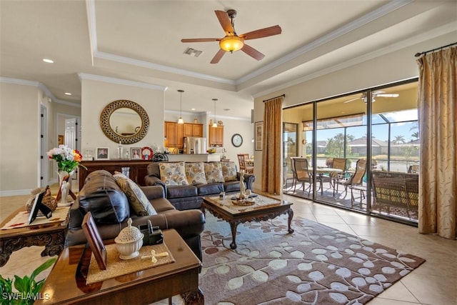 living room with visible vents, crown molding, light tile patterned floors, a raised ceiling, and a ceiling fan