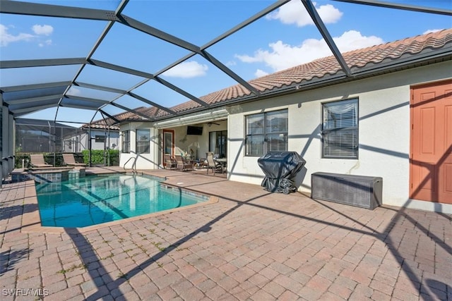 view of pool featuring a patio area, a lanai, a pool with connected hot tub, and ceiling fan