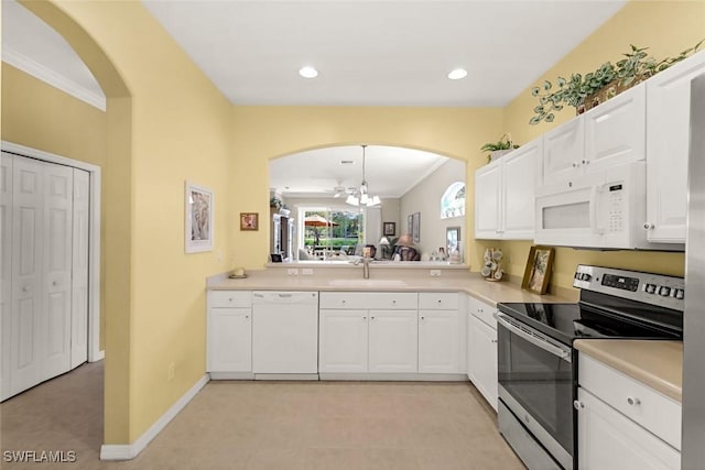 8339 Langshire Way, Fort Myers, FL 33912 - kitchen with light countertops, a sink, arched walkways, white appliances, and white cabinetry