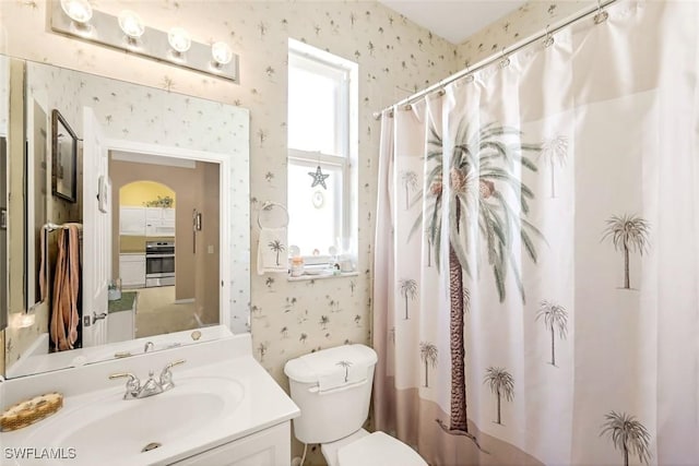 8339 Langshire Way, Fort Myers, FL 33912 - bathroom with toilet, vanity, curtained shower, and wallpapered walls