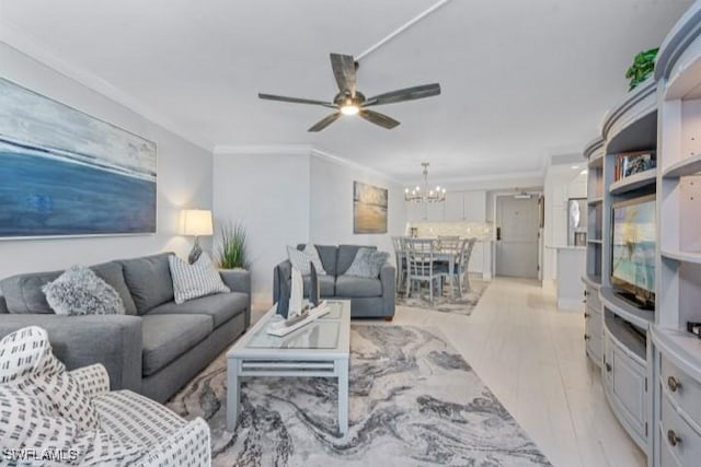 living room with crown molding and ceiling fan with notable chandelier