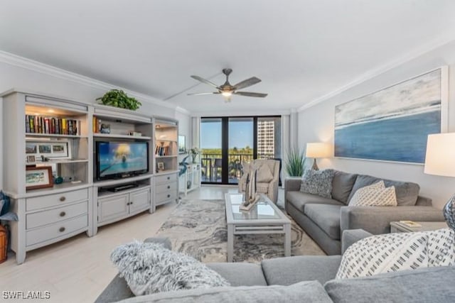 living room featuring a ceiling fan and ornamental molding