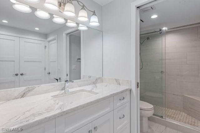 bathroom featuring vanity, toilet, recessed lighting, and a stall shower