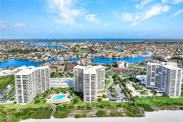 drone / aerial view featuring a city view and a water view