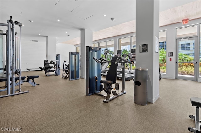 workout area featuring recessed lighting and baseboards