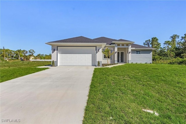 prairie-style home featuring stucco siding, a front lawn, concrete driveway, and an attached garage