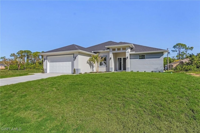 prairie-style home featuring an attached garage, concrete driveway, and a front yard