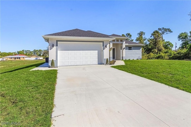 prairie-style home featuring a front lawn, an attached garage, and stucco siding