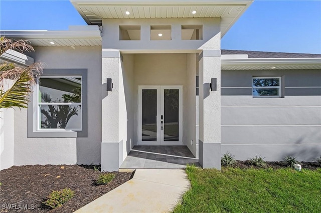 doorway to property featuring french doors and stucco siding