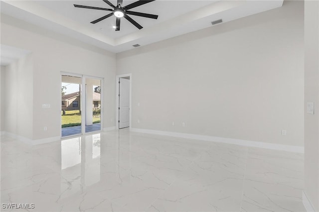 empty room featuring visible vents, marble finish floor, baseboards, and ceiling fan