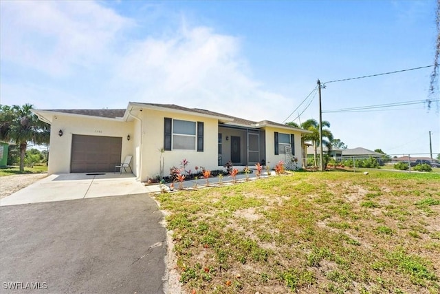 ranch-style home with stucco siding, driveway, and an attached garage
