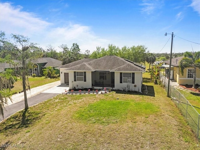 view of front facade featuring fence, concrete driveway, a front yard, stucco siding, and a garage