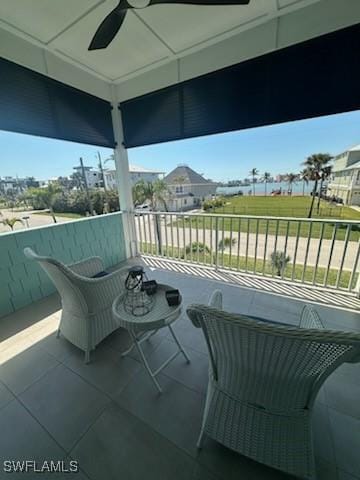 view of patio / terrace with a balcony and a ceiling fan