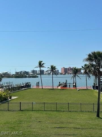 view of yard featuring a water view and fence