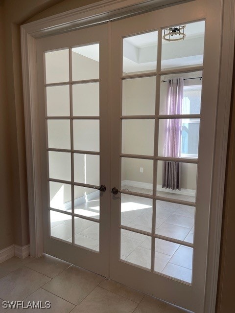 doorway to outside featuring light tile patterned floors and french doors