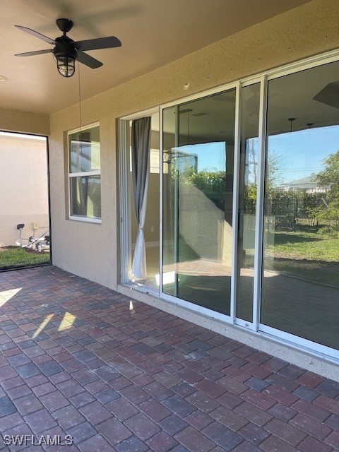 view of patio featuring ceiling fan