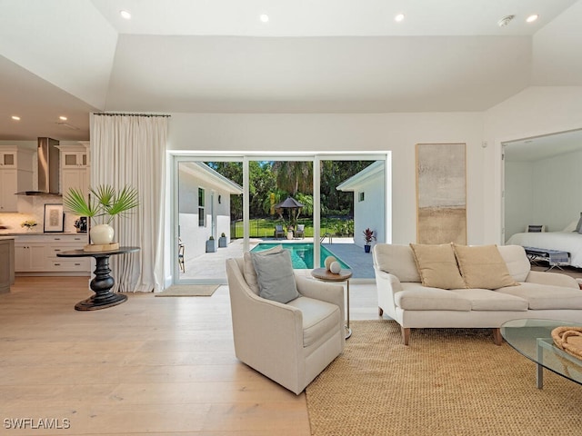 living room with light wood-type flooring, lofted ceiling, and recessed lighting