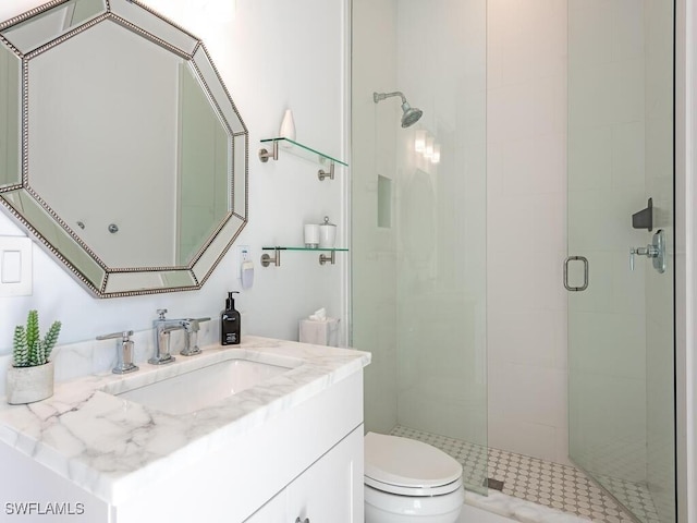 full bathroom featuring vanity, toilet, and a shower stall