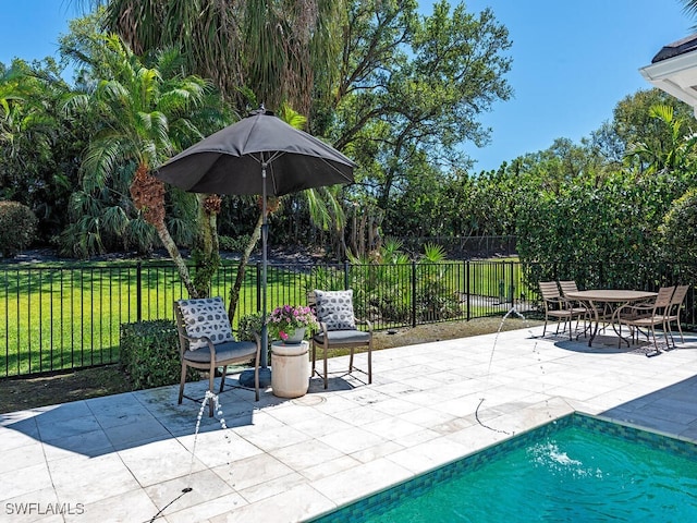 view of pool with a yard, a patio area, a fenced in pool, and fence