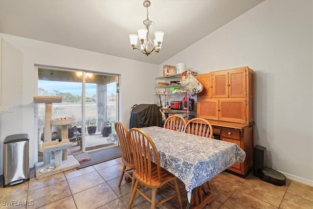 dining area featuring light tile patterned flooring, a notable chandelier, baseboards, and lofted ceiling