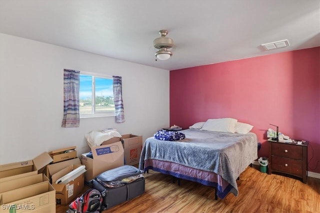 bedroom featuring wood finished floors and visible vents