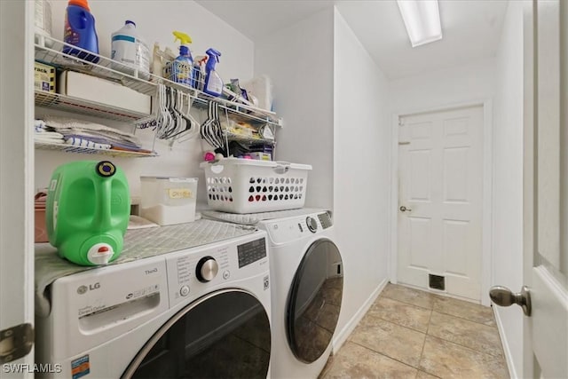 washroom with washing machine and clothes dryer, laundry area, baseboards, and light tile patterned floors