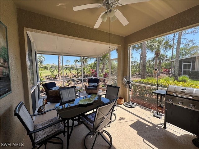 sunroom / solarium with a wealth of natural light, lofted ceiling, and ceiling fan