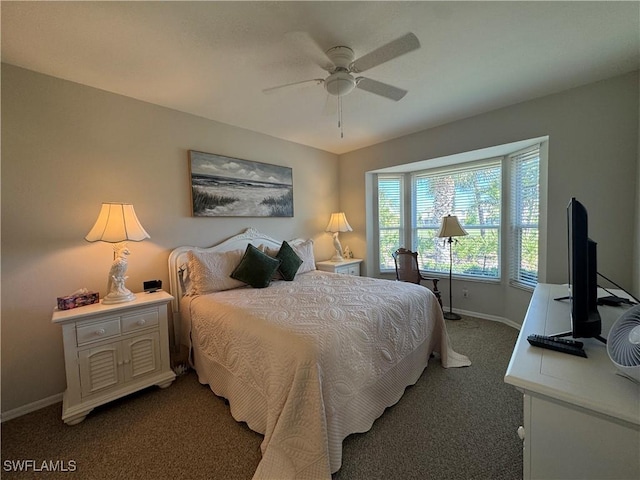 carpeted bedroom featuring baseboards and a ceiling fan