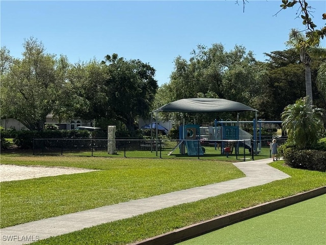 surrounding community with a lawn, playground community, and fence