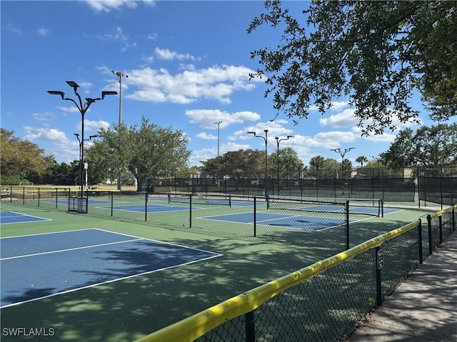 view of sport court featuring fence