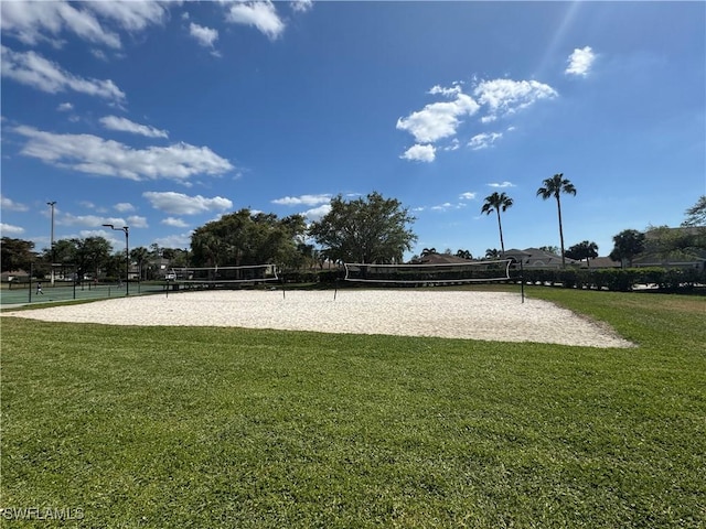 view of property's community with volleyball court and a yard