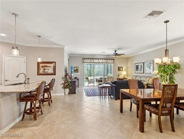 13117 Cardeto Ct, Estero, FL 33928 - dining area with visible vents, crown molding, baseboards, ceiling fan, and light tile patterned floors