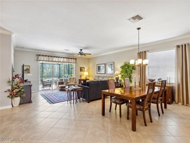 13117 Cardeto Ct, Estero, FL 33928 - dining room with light tile patterned floors, visible vents, crown molding, and ceiling fan with notable chandelier
