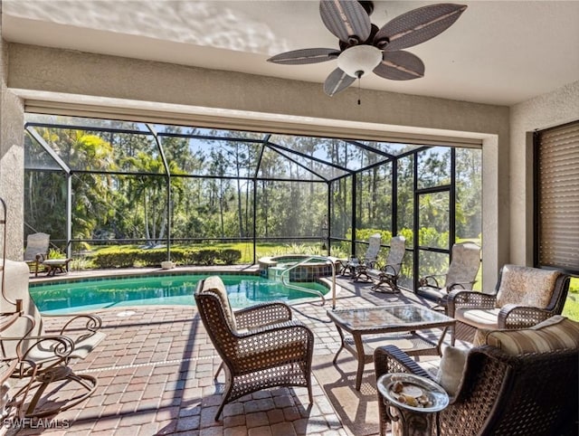 13117 Cardeto Ct, Estero, FL 33928 - view of swimming pool featuring glass enclosure, a patio, ceiling fan, and a pool with connected hot tub